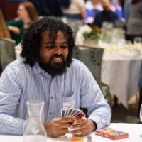 person smiling at luncheon table
